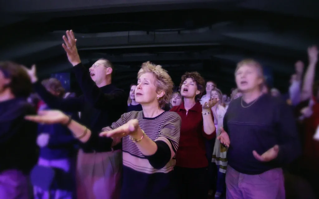 A group of people worshipping in church after Digital Evangelist transformed their leadership